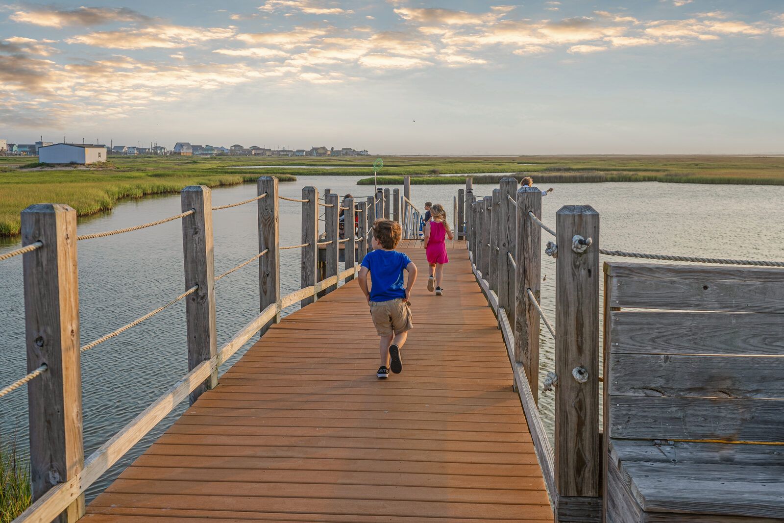 Children walking toward the private crabbing pier at Seahorse